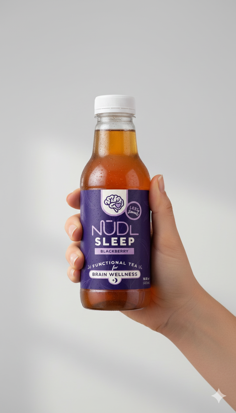 Hand holding NŪDL Sleep Tea bottle
